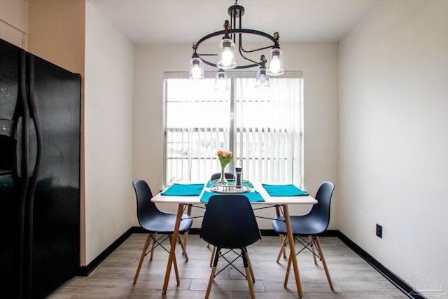 dining area featuring a chandelier and light hardwood / wood-style flooring