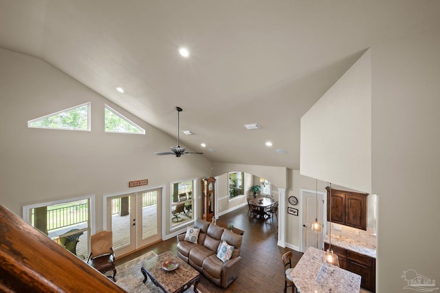 living area featuring recessed lighting, arched walkways, dark wood-style flooring, and a wealth of natural light