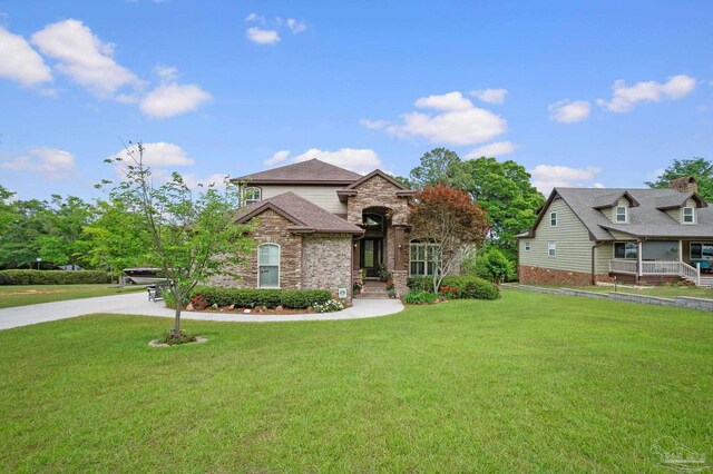 french country inspired facade featuring a front lawn and stone siding