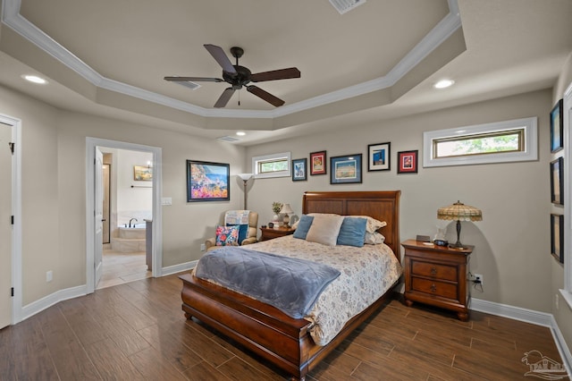 bedroom featuring crown molding, wood finished floors, and a tray ceiling