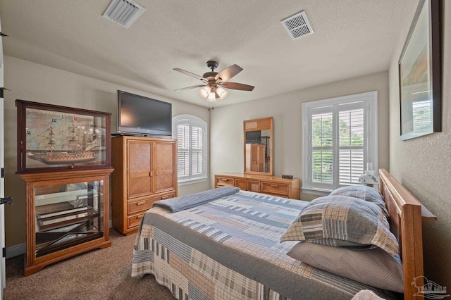 carpeted bedroom with visible vents and ceiling fan