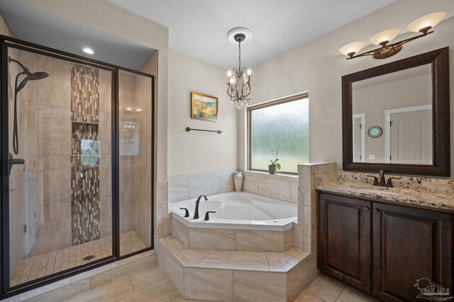 bathroom with tile patterned flooring, vanity, a bath, and a stall shower