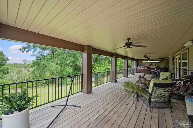 wooden deck with ceiling fan and an outdoor hangout area
