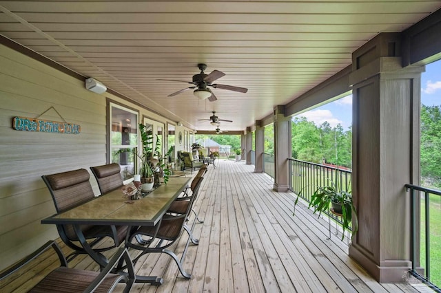 deck featuring a ceiling fan and outdoor dining area