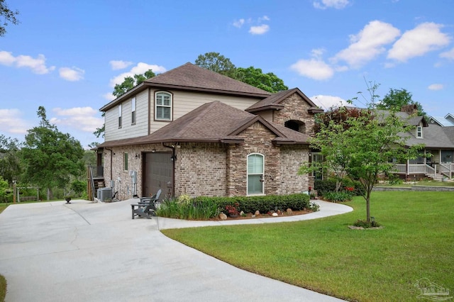 french provincial home featuring brick siding, a shingled roof, driveway, central AC, and a front lawn
