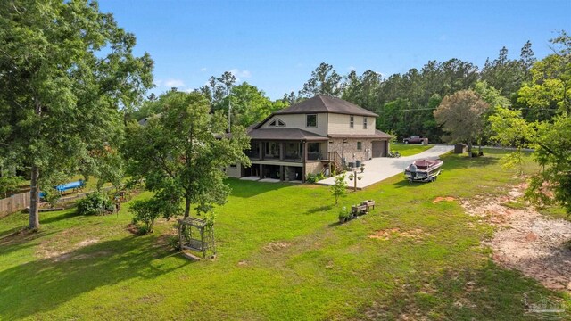 exterior space featuring driveway and a lawn