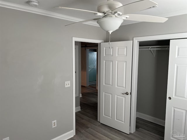 unfurnished bedroom with dark hardwood / wood-style flooring, ornamental molding, a closet, and ceiling fan