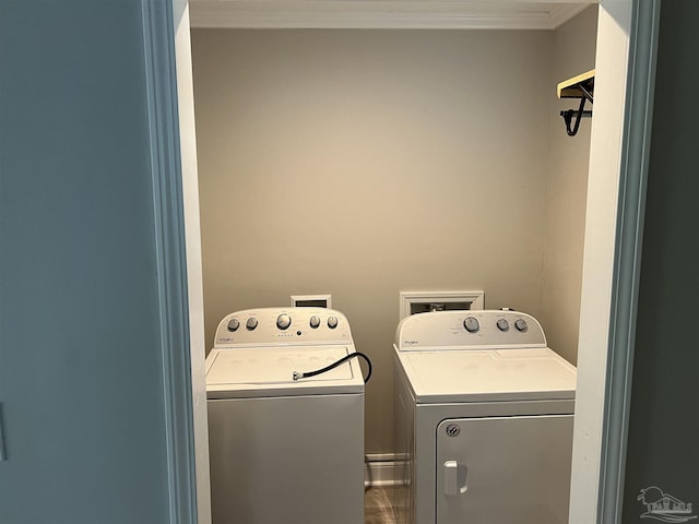 laundry area with washer and clothes dryer and ornamental molding