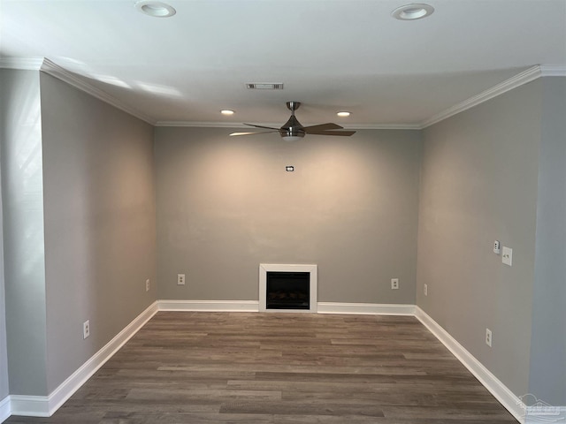 spare room with dark wood-type flooring, ceiling fan, and ornamental molding