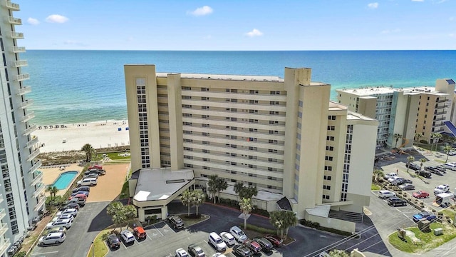 drone / aerial view featuring a water view and a beach view