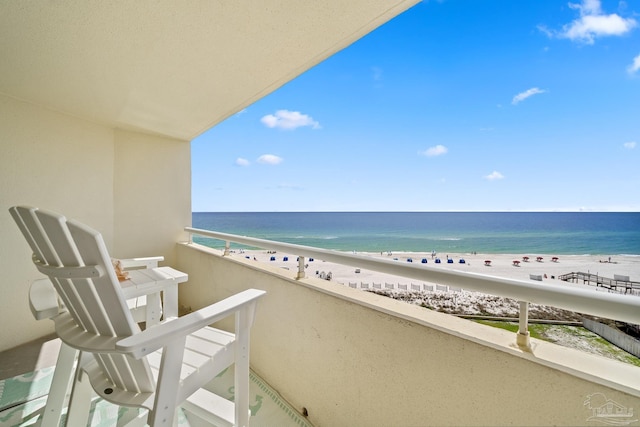 balcony with a water view and a beach view