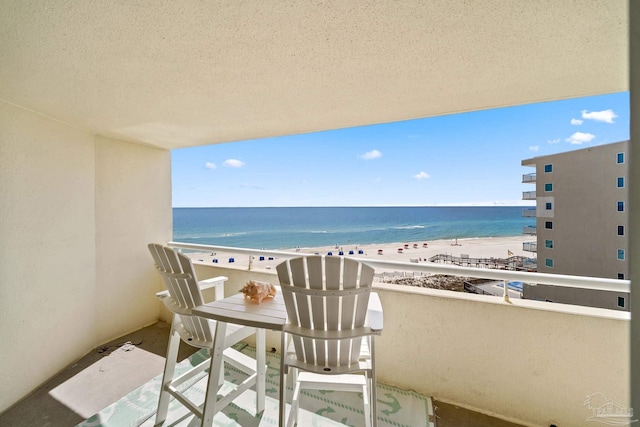 balcony with a view of the beach and a water view