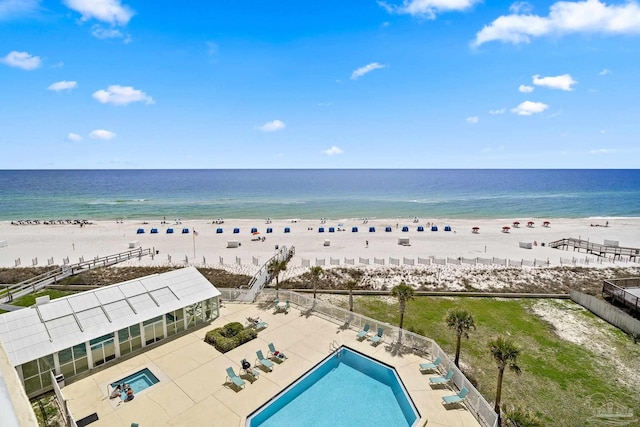 exterior space with a water view and a beach view