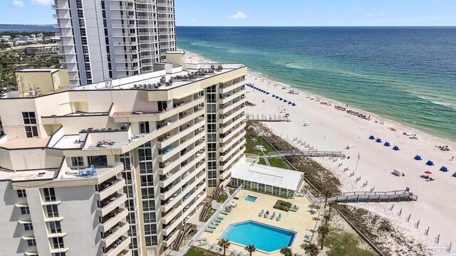 birds eye view of property with a water view and a view of the beach