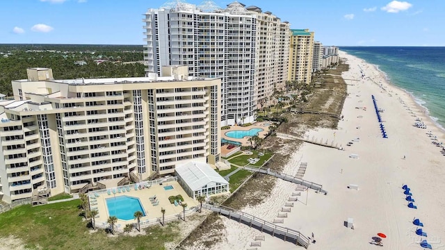 birds eye view of property with a water view and a view of the beach