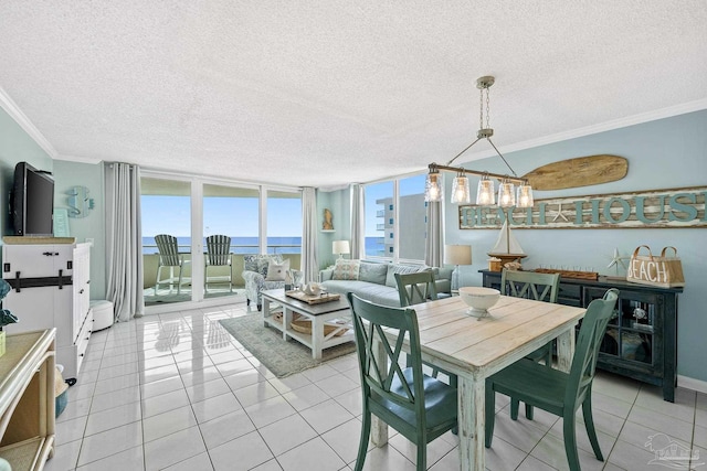 dining space featuring light tile patterned floors, a wall of windows, ornamental molding, and a textured ceiling