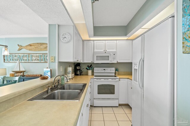 kitchen featuring sink, white cabinetry, white appliances, and light tile patterned floors