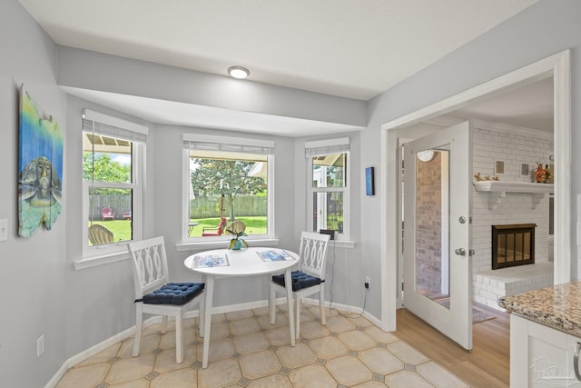 dining area featuring baseboards and a fireplace