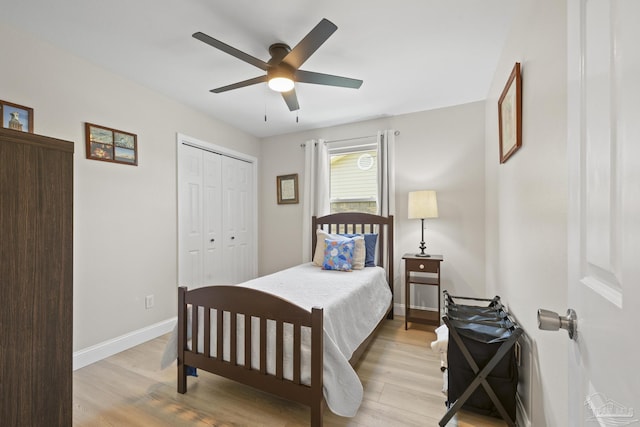 bedroom with a closet, ceiling fan, baseboards, and light wood-style floors