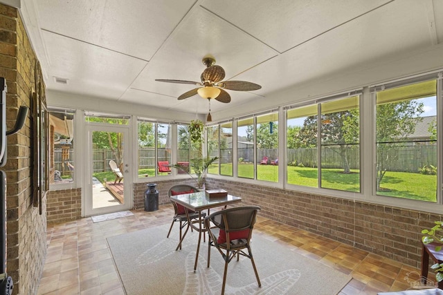 sunroom / solarium featuring visible vents and ceiling fan