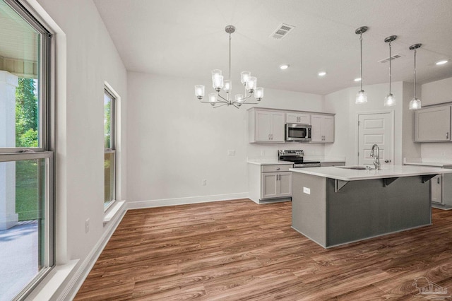 520 K St, Pensacola, FL 32501 - kitchen with stainless steel appliances, a sink, healthy amount of natural light, gray cabinetry, and recessed lighting