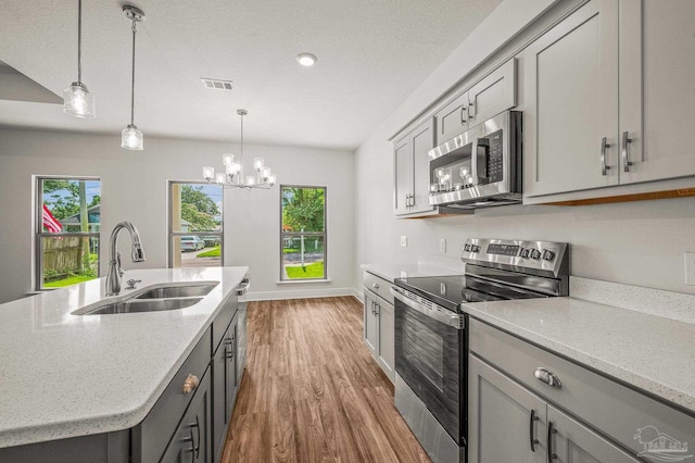 520 K St, Pensacola, FL 32501 - kitchen featuring stainless steel appliances, gray cabinetry, and a sink