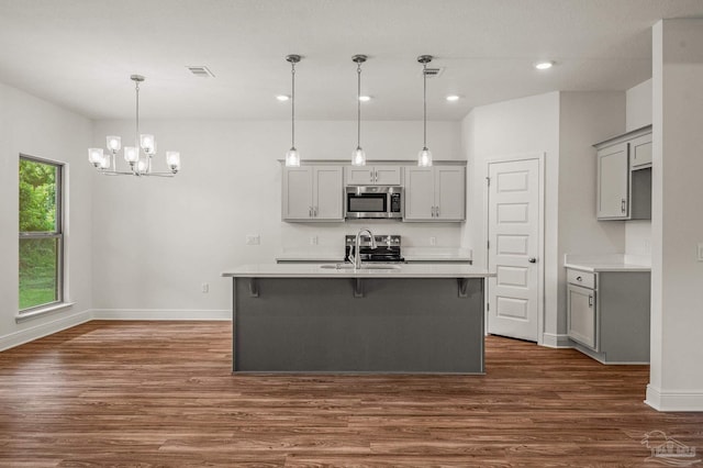 520 K St, Pensacola, FL 32501 - kitchen featuring stainless steel appliances, gray cabinets, dark wood finished floors, a sink, and baseboards
