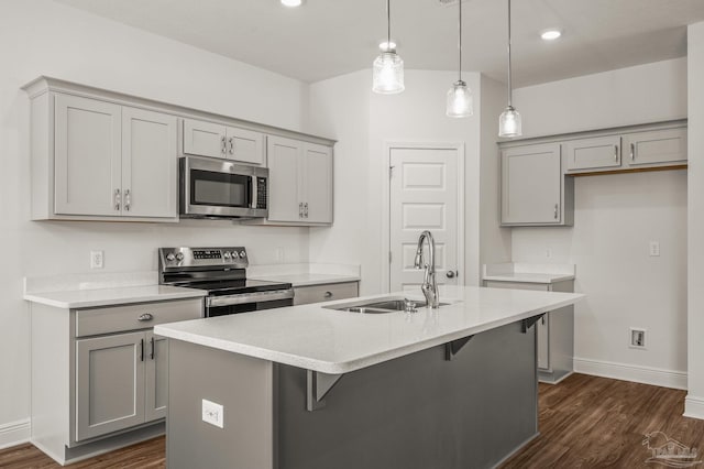 520 K St, Pensacola, FL 32501 - kitchen with appliances with stainless steel finishes, gray cabinetry, a sink, dark wood finished floors, and baseboards