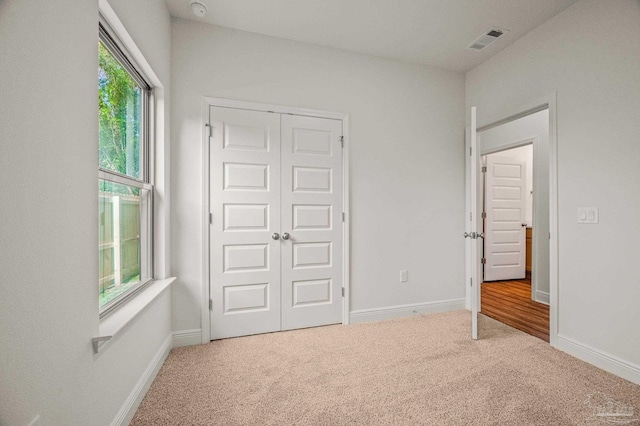 520 K St, Pensacola, FL 32501 - unfurnished bedroom with carpet, a closet, and baseboards