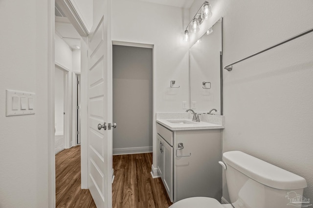 520 K St, Pensacola, FL 32501 - half bath with vanity, wood finished floors, toilet, and baseboards