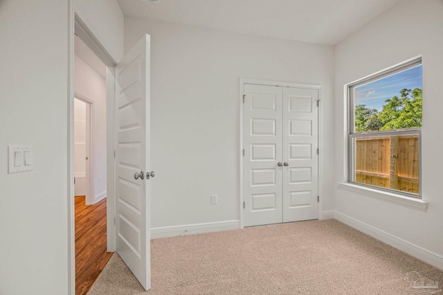 520 K St, Pensacola, FL 32501 - unfurnished bedroom with carpet floors, a closet, and baseboards