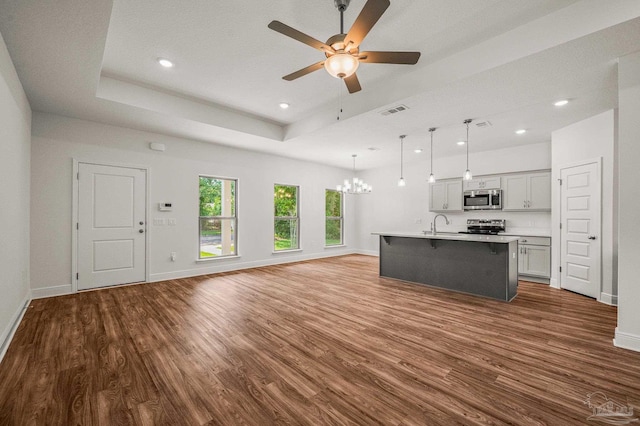 520 K St, Pensacola, FL 32501 - unfurnished living room with dark wood-type flooring, ceiling fan, baseboards, a chandelier, and recessed lighting