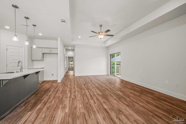 520 K St, Pensacola, FL 32501 - unfurnished living room with a sink, wood finished floors, a ceiling fan, baseboards, and recessed lighting