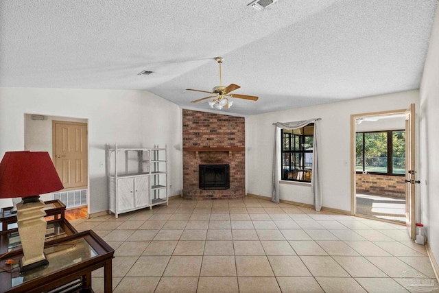 tiled living room with a textured ceiling, ceiling fan, lofted ceiling, and a brick fireplace