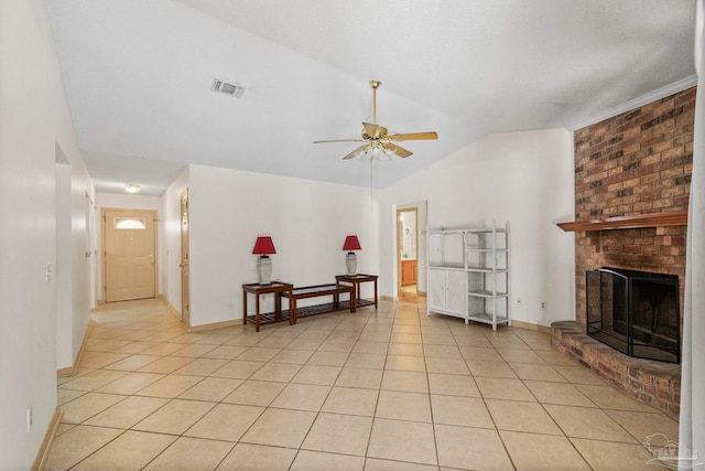 living room with a fireplace, light tile patterned floors, ceiling fan, and lofted ceiling