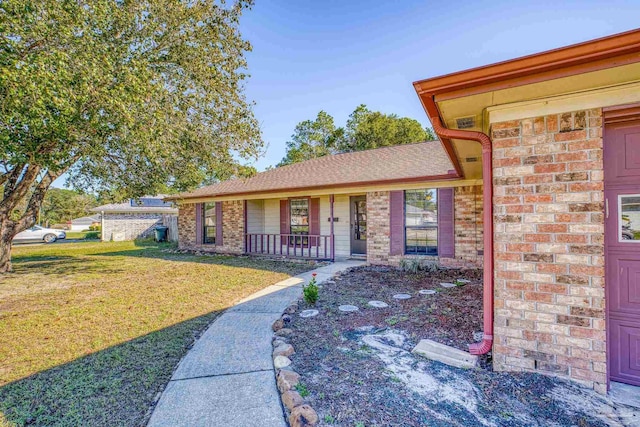 view of front of house with a front yard and covered porch