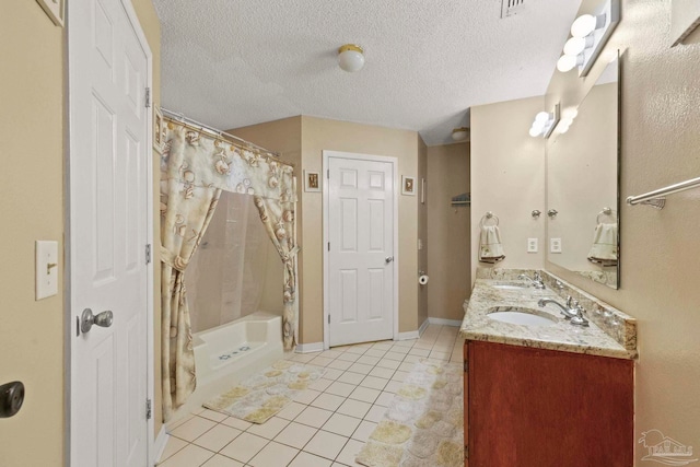 bathroom with a textured ceiling, vanity, tile patterned floors, and shower / tub combo with curtain