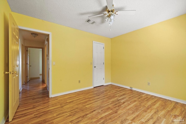 unfurnished bedroom with ceiling fan, a textured ceiling, and light hardwood / wood-style flooring