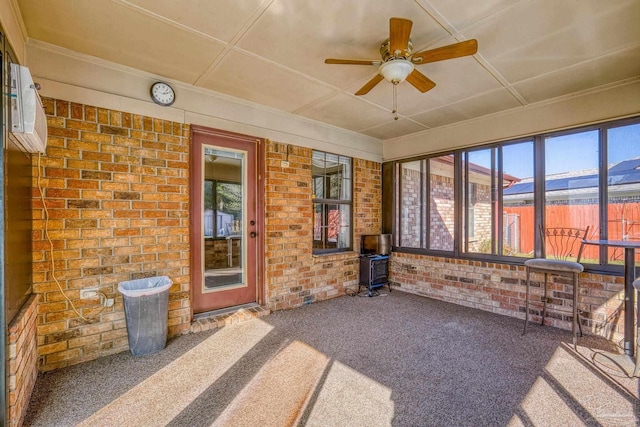 sunroom featuring ceiling fan