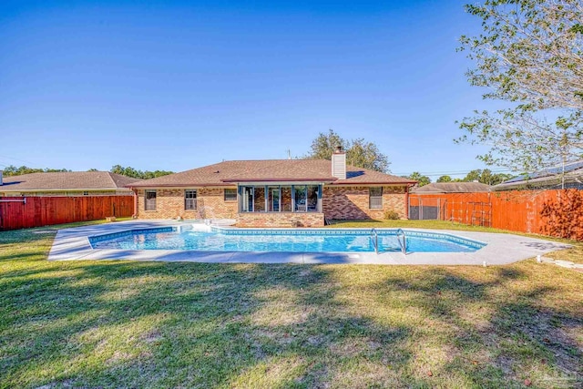 view of pool featuring a yard