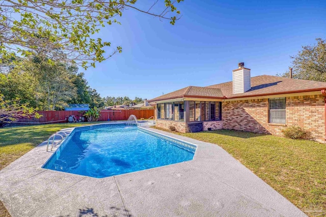 view of pool with a yard