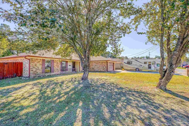 view of front of property featuring a garage and a front lawn