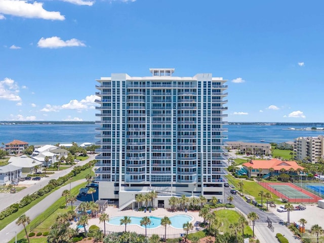 exterior space with a water view and a community pool