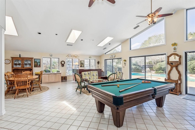 playroom with a healthy amount of sunlight, light tile patterned floors, and high vaulted ceiling