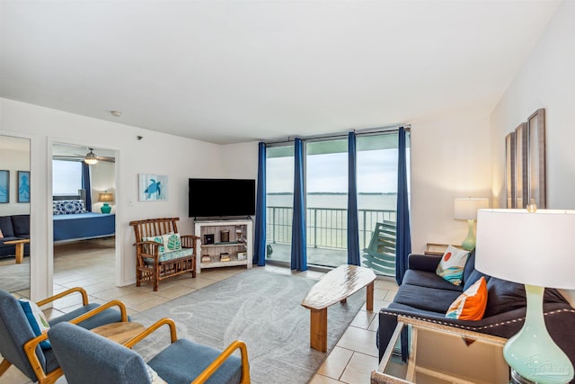 tiled living room with ceiling fan