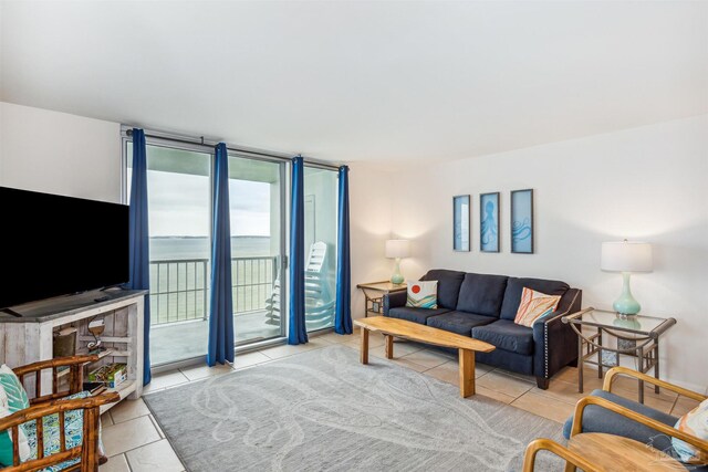 living room featuring ceiling fan and light tile patterned flooring