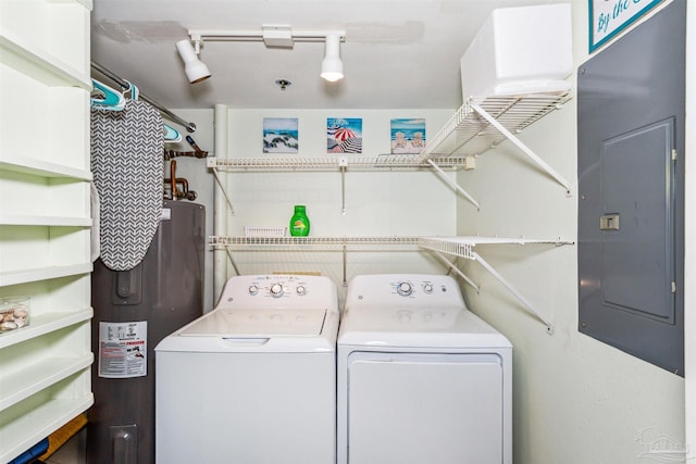 clothes washing area with electric water heater, electric panel, and independent washer and dryer