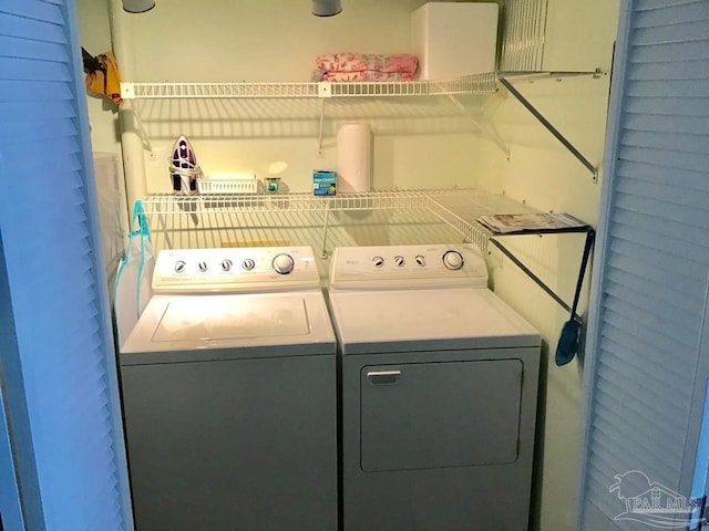 clothes washing area with washing machine and clothes dryer