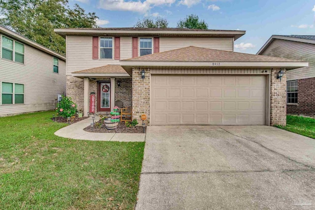 view of property featuring a garage and a front lawn