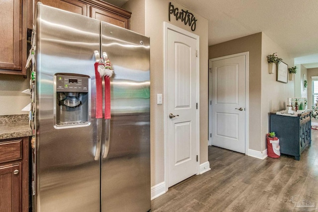 kitchen with stainless steel fridge with ice dispenser and dark hardwood / wood-style floors